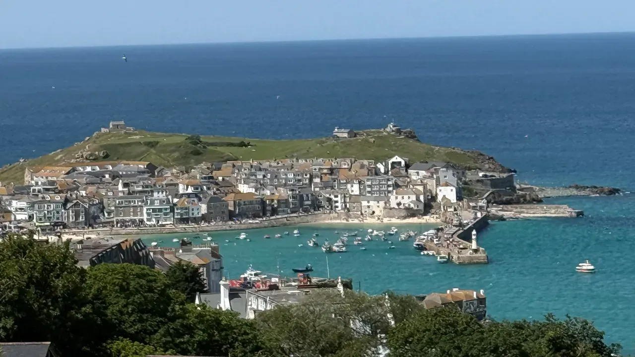 St Ives, Cornwall: the harbour, headland and turquoise bay seen from the hill above town.