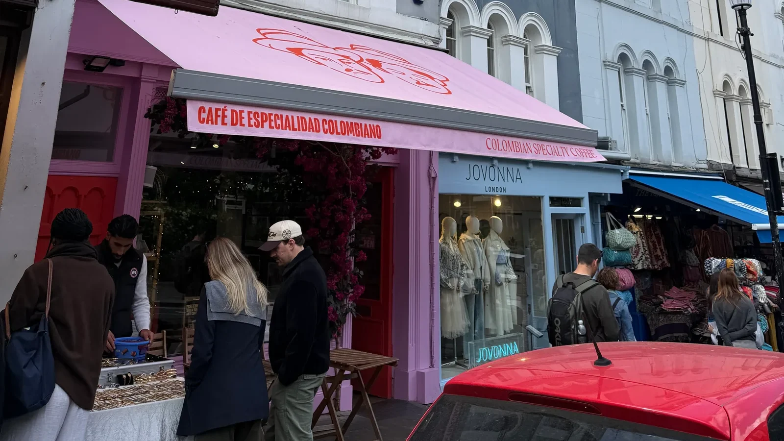Hermanos Colombian Coffee Roasters storefront on Portobello Road, Notting Hill, London — iconic pink awning over the cafe entrance.