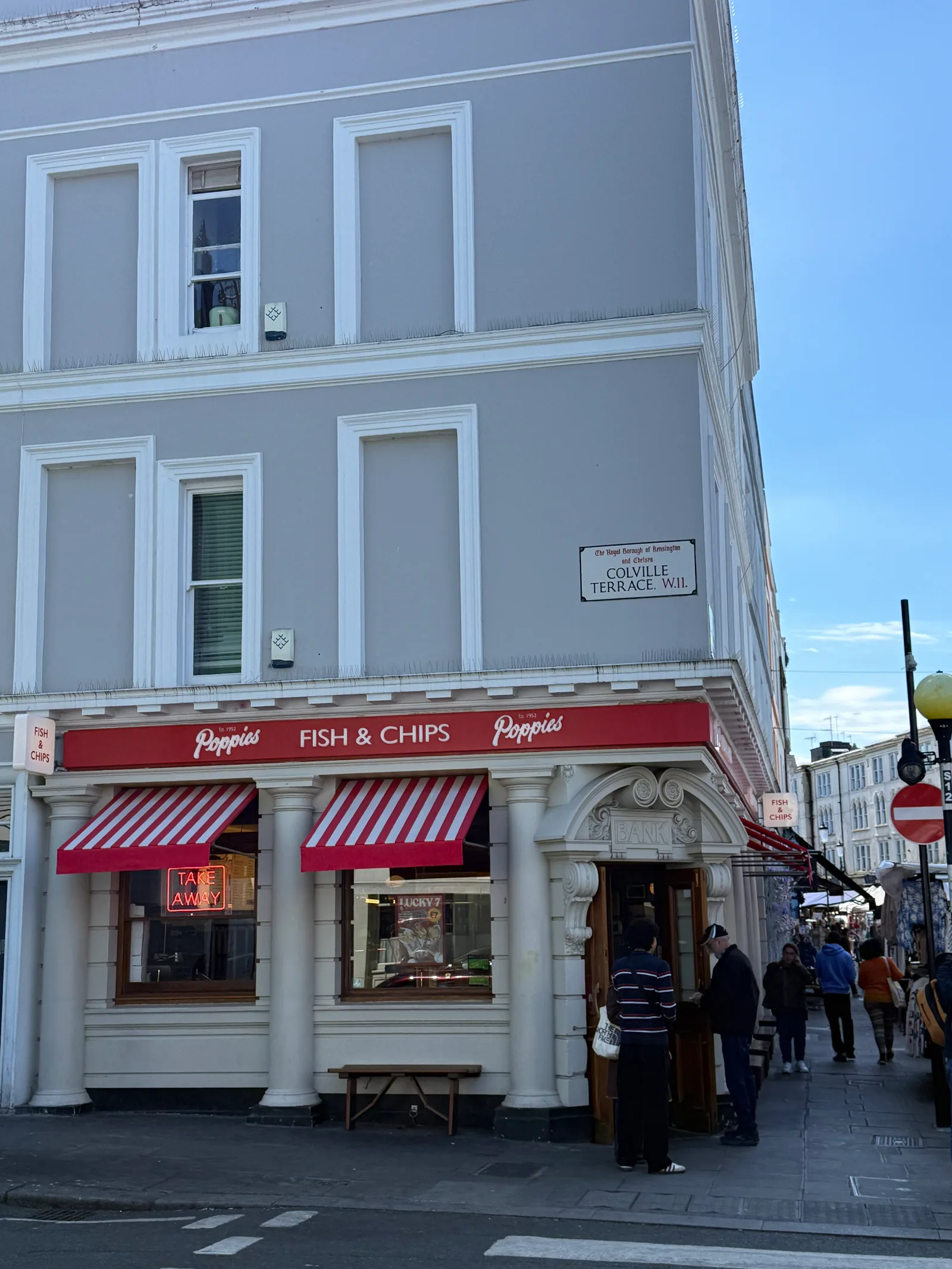 Poppies Fish and Chips at 152 to 154 Portobello Road in Notting Hill, the red and white striped awning of the chippy that opened in an old bank building in April 2024